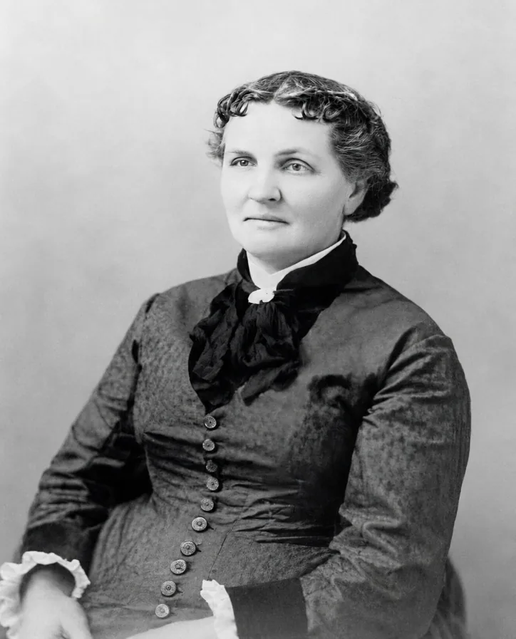 Black-and-white portrait of Lydia Helen Lott Hardy, seated, in a dark buttoned dress with a large bow at the neck
