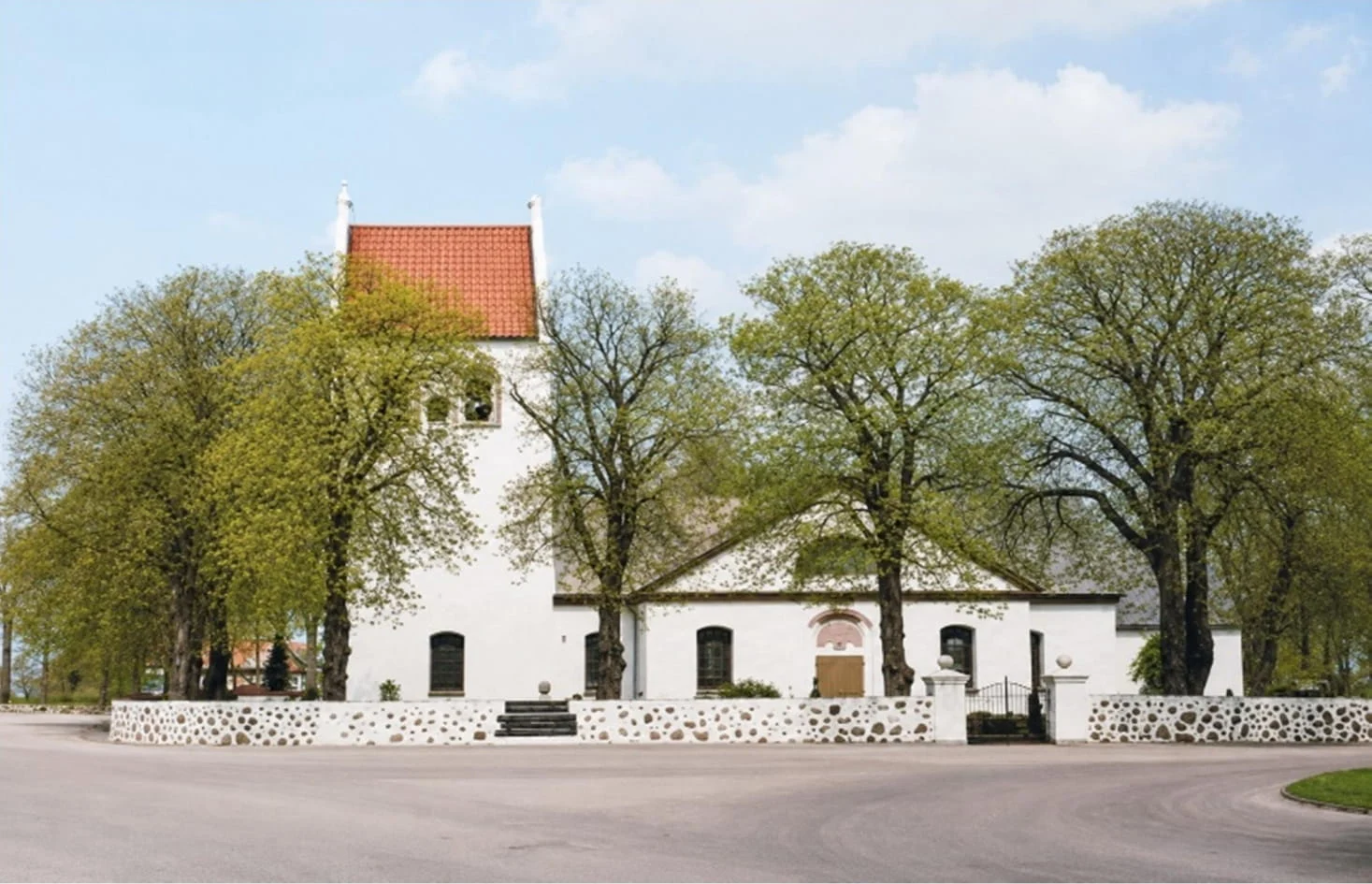 Photograph of Allerum parish church, a white church with a red-tiled tower, taken by Mildred Morse about 1983